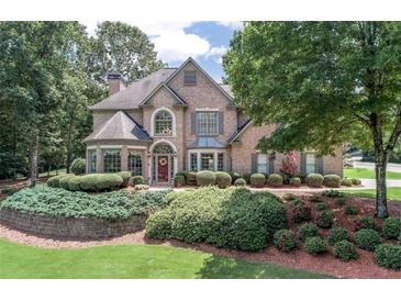 Charming brick two-story home with a beautifully landscaped front yard and inviting curb appeal at 1720 Monarch Ct, Cumming, GA 30041