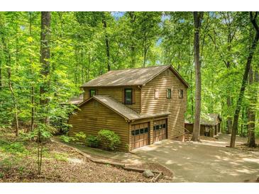 Charming cabin-style home with a two-car garage nestled amongst mature trees at 2269 Sparrow Ridge Ne Dr, Marietta, GA 30066