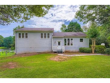 Charming two-story home with a spacious lawn and lush green surroundings at 2538 Morgan Lake Ne Dr, Marietta, GA 30066