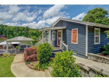 Charming blue home with a landscaped yard, covered dock, and tranquil lake views at 22 Waters Bridge Cir, Covington, GA 30014