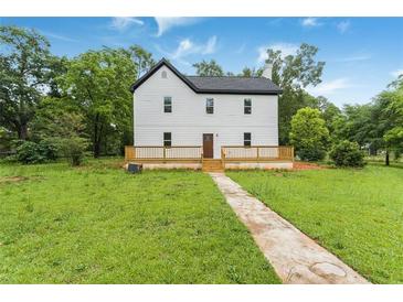 Charming two-story home with a dark roof and newly installed light-colored wood deck at 331 Highway 162, Covington, GA 30016