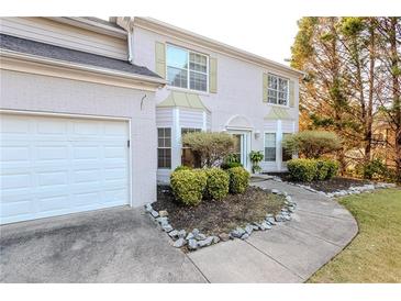 Charming two-story home with a well-manicured front yard and attached garage provides comfortable living at 335 Wilma Sw Ct, Atlanta, GA 30331