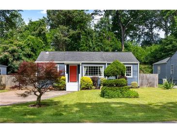Charming blue home with a bright red door and a well-manicured lawn with lush landscaping at 1090 Shepherds Ne Ln, Atlanta, GA 30324