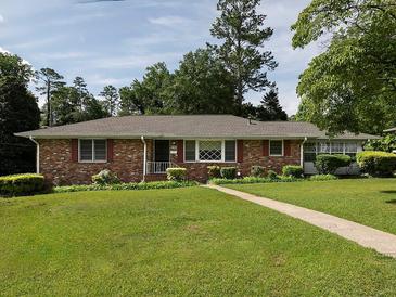 Charming brick home featuring a lush green lawn and mature trees at 286 Sequoia Ne Dr, Marietta, GA 30060