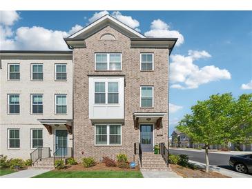 Charming brick townhouse with well-manicured front yard and inviting entrance at 1621 Wellborn Walk, Suwanee, GA 30024
