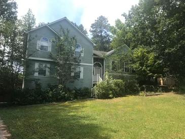 Charming two-story home with lush lawn and mature trees offering great curb appeal at 1050 Queensbury Run, Acworth, GA 30102