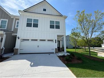 Charming two-story home featuring a two-car garage and beautifully landscaped front yard at 1177 Chastain Dr, Sugar Hill, GA 30518