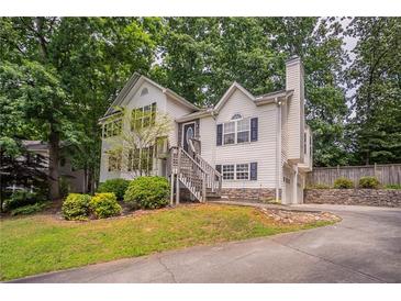 Charming two-story home with front yard landscaping, stone accents and driveway at 962 Taylors Farm Ct, Canton, GA 30115