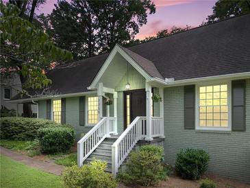 Charming home with a covered porch, painted brick, and landscaped front yard at 2259 Eastway Rd, Decatur, GA 30033