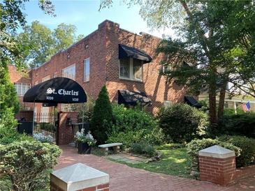 Beautiful brick apartment building with a manicured lawn and shade trees at 1026 Saint Charles Ne Ave # 15, Atlanta, GA 30306