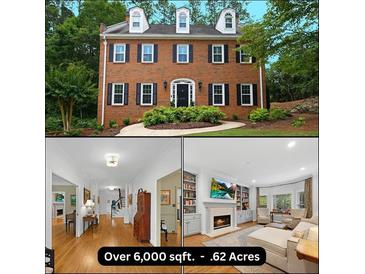 Two-story brick home with black shutters, dormer windows, and a curved walkway surrounded by mature trees at 4250 Green Ridge Dr, Marietta, GA 30062