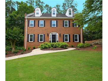 Charming brick two-story home featuring a well-manicured lawn and inviting walkway at 4250 Green Ridge Dr, Marietta, GA 30062