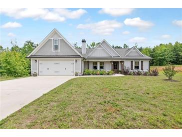 Charming single-Gathering home with a manicured lawn, two-car garage, and inviting curb appeal at 2241 N 16 Hwy, Whitesburg, GA 30185