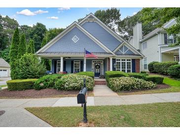 Charming home with blue siding, manicured landscaping, and a welcoming front porch at 400 Pringle Dr, Suwanee, GA 30024