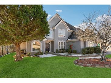 Charming two-story home with well-manicured lawn and mature trees at 4497 Black Water Cv, Ellenwood, GA 30294
