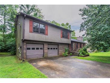 Charming two-story home featuring a two-car garage and nicely landscaped surroundings at 1744 Cum Laude Way, Lawrenceville, GA 30044