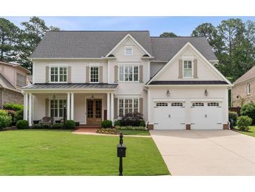 Beautiful two-story home with a manicured lawn, attached two-car garage, and inviting front porch with brickwork at 1860 Leighton Ln, Marietta, GA 30062