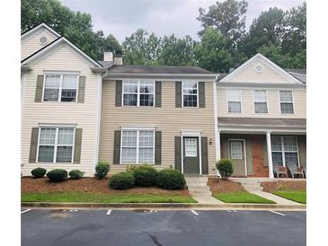 Traditional townhouse with neutral siding, green shutters, tidy lawn, and parking area at 4645 Valais Ct # 10, Johns Creek, GA 30022