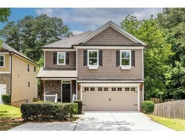 Charming two-story home with a welcoming front porch and attached two-car garage at 1542 Idlewood Rd, Tucker, GA 30084