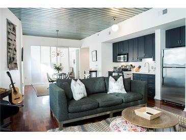 Open-concept living room featuring a modern kitchen, dining area, and comfortable seating at 620 Glen Iris Dr # 223, Atlanta, GA 30308