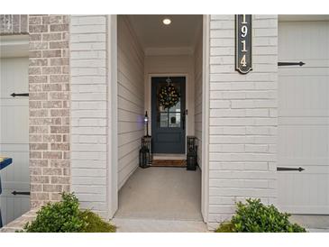Inviting front entrance with decorative wreath and stylish black door at 1914 Carovel Way, Kennesaw, GA 30144