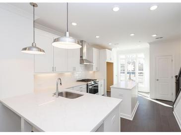 Modern kitchen featuring stainless steel appliances, white cabinets, quartz counters, and an island at 354 Olmstead Way # 27, Alpharetta, GA 30022