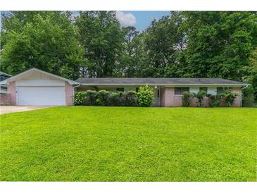 Charming single-story home with a large front yard and lush greenery, offering great curb appeal at 460 E Kildare Nw Ave, Atlanta, GA 30318