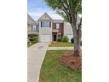 Charming townhouse with a brick facade, a one-car garage, and a well-manicured lawn and landscaping at 359 Azalea Cir, Cumming, GA 30028