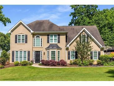 Charming two-story home with a well-manicured lawn and a traditional design at 4913 Farm Valley Ne Dr, Woodstock, GA 30188