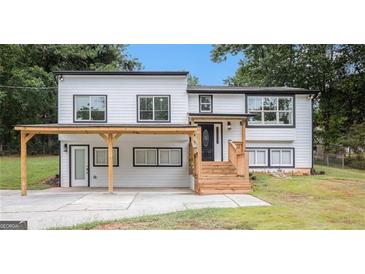 Charming renovated two-story home featuring new windows, modern finishes, and a welcoming covered porch area at 3831 Flakes Mill Rd, Decatur, GA 30034