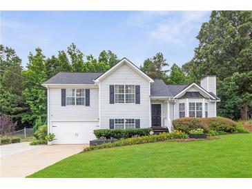 Charming two-story home with a well-maintained lawn, black door, and inviting curb appeal at 7108 Hummingbird Ln, Winston, GA 30187