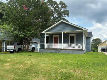 Charming single-story home featuring a cozy front porch and well-maintained lawn at 2268 Newnan St, Atlanta, GA 30344