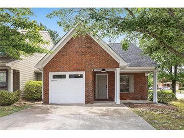 Charming brick home features a one-car garage, covered porch, and well-maintained front yard at 3063 Broadleaf Trl, Fairburn, GA 30213