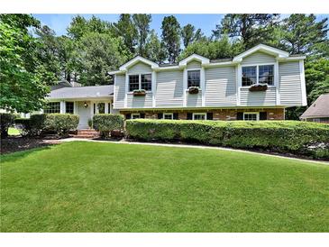 Charming two-story home with manicured lawn and lush landscaping, offering curb appeal at 3107 Bunker Hill Cir, Marietta, GA 30062
