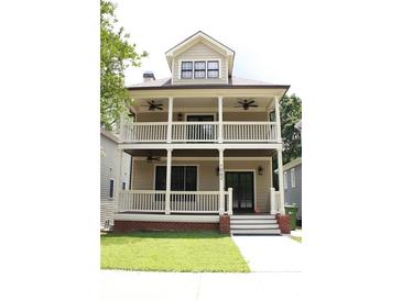 Charming two-story home featuring a double-decker front porch, perfect for enjoying outdoor living at 1062 Lena Nw St, Atlanta, GA 30314