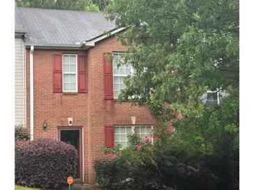 Two-story brick home with red shutters and a well-maintained front yard at 338 Saratoga Pl, Riverdale, GA 30296