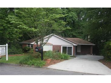 Charming brick home with a well-manicured front yard and an inviting entrance at 1102 Rogeretta Ne Dr, Atlanta, GA 30329
