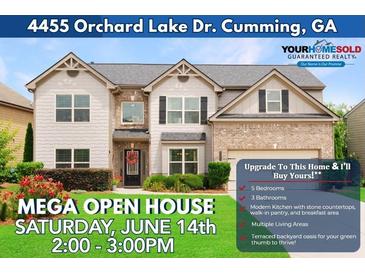 Charming two-story home featuring a combination of siding and brick, with a manicured front yard and inviting curb appeal at 4455 Orchard Lake Dr, Cumming, GA 30028