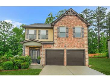 Charming two-story brick home with a two-car garage and well-manicured lawn at 364 Mossycup Dr, Fairburn, GA 30213