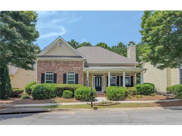 Charming one-story home with a well-maintained lawn and mature landscaping at 557 Pringle Dr, Suwanee, GA 30024