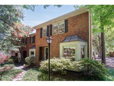 Brick townhouse with manicured front yard landscaping, black shutters and large windows at 1348 Sheffield Glen Ne Way # 8, Atlanta, GA 30329