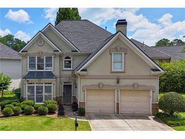 Charming two-story home featuring a manicured lawn, two-car garage, and neutral color scheme at 2459 Chestnut Lndg, Atlanta, GA 30360