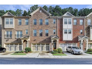 Charming townhome with brick exterior, two-car garage, and beautifully landscaped front yard at 4232 Perimeter E Park # 110, Atlanta, GA 30341
