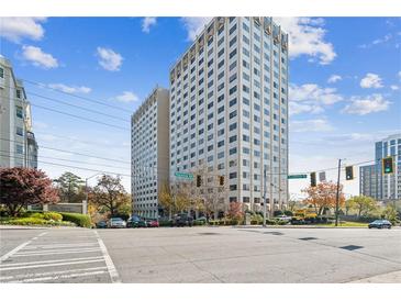 View of The Regency building featuring an expansive front lawn and city views at 2479 Peachtree Ne Rd # 1703, Atlanta, GA 30305