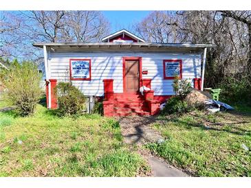 Charming home with red accents, a small porch, and a well-maintained front yard at 692 Moreland Se Ave, Atlanta, GA 30316