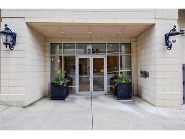 The building entrance features double glass doors, black flower boxes, and a secure access system at 2255 Peachtree Ne Rd # 620, Atlanta, GA 30309