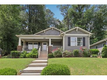 Charming home featuring a welcoming front porch, well-maintained lawn, and beautifully landscaped garden at 532 Lemon Ne St, Marietta, GA 30060