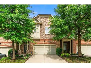 Charming townhome with a brick and stone exterior and well-maintained landscaping at 5534 Parkerton Ln, Atlanta, GA 30342