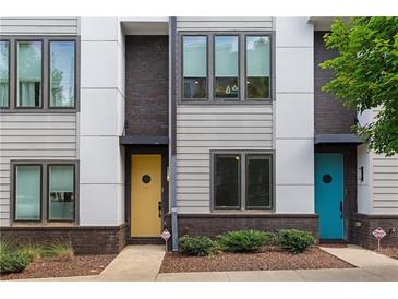 Modern townhome with colorful front doors, gray siding, and brick accents, set on a neatly landscaped lot at 415 Gartrell Se St # 15, Atlanta, GA 30312