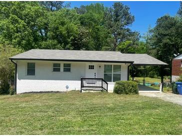 Charming single-story home with a white brick facade, covered porch, and well-maintained front yard at 3199 Nw Delmar Ln, Atlanta, GA 30311